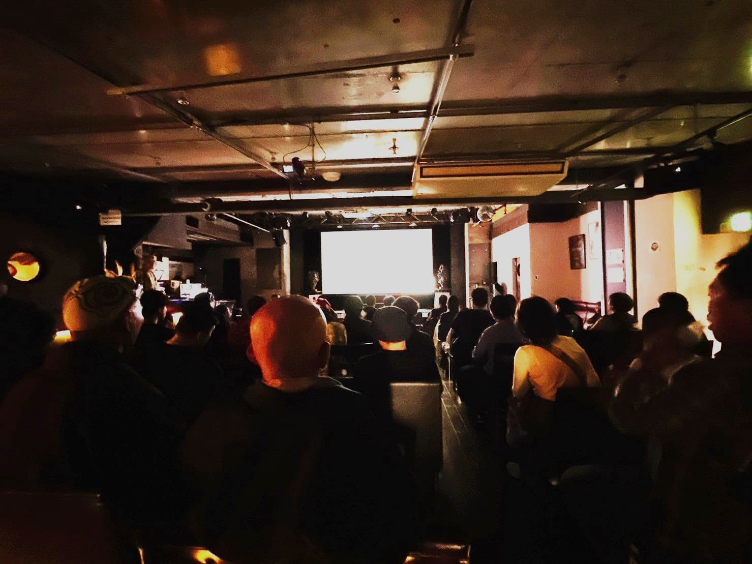 A full house at LOFT9 Shibuya watching a film on screen